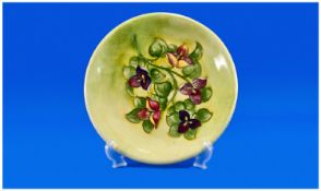 Moorcroft Cabinet Plate, `Bougainvillea Design`. Yellow and green ground. Signed to underside. 10.