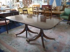 Georgian Style Mahogany Double Pedestal Dining Table, with two leaves, the legs with brass castor