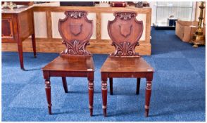 Pair of Mid Victorian Mahogany Hall Chairs, with shield shaped backs, each with a vacant cartouche