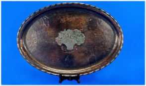 A Large Hugh Wallis Oval Copper Tray (1871-1943). Decorated to the centre with a pewter inlaid