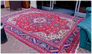Large Hand Made Persian Carpet, early 20th century, symmetrical decoration on a deep red ground.