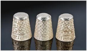 A Set of Three Identical Silver Thimbles. Each decorated with raised circular designs and Greek key