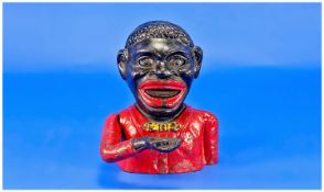 Jolly Nigger Bank, in the form of a black boy money box, his hand lifting up towards his mouth and