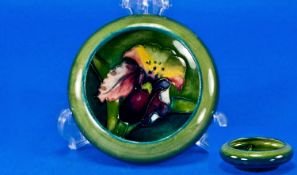 Moorcroft Small Inverted Bowl, ``Orchid`` design on bluey green ground. 4.25 inches diameter.