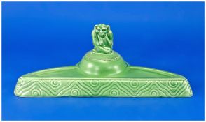 Early Twentieth Century Wedgwood Pale Green Ink Stand, the ink well surmounted by a monkey, the