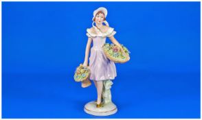 Royal Dux Figure, `Girl Flower Seller, with pink triangle to underside of base, 10 inches high.