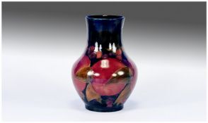 William Moorcroft Signed Vase, pomegranate design on blue ground circa 1920`s, 7`` in height.