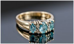 10ct Gold Set Three Stone Aquamarine and Diamond Dress Ring. Stamped 10k.