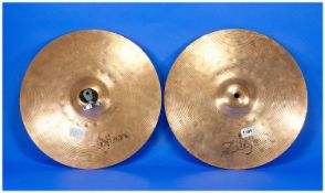 Pair of Brass Zildjian Cymbals, circular ridges to top, each measuring 14 inches in diameter. This
