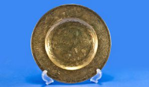 Brass Oriental Dish, with broad rim, with simple engraving to front, crest to back and signed `
