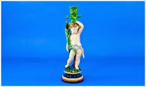 Minton Majolica Figural Candlestick, a naked putto, holding a sheaf of bullrushes by his right hip,
