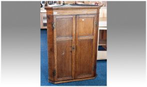 19th Century Oak Corner Cupboard, of hanging form, fitted with over hanging moulded cornice, fitted