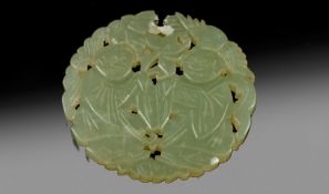 A Fine Chinese Pale Jade Pendant Disc, intricately pierced and carved, depicting two seated boys