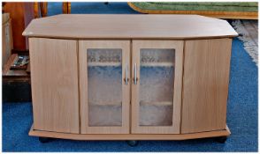 Contemporary TV Stand, in beech effect, with cabinet section below.