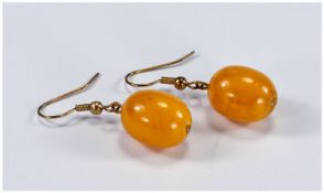 Yellow Amber Drop Earrings, oval drops on shepherd`s hook fittings; 1.5 inch drop overall