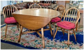 Ercol Dining Table and Four Chairs, the table of drop leaf form, with elm top, the chairs of