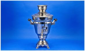 Chrome Samovar with black carrying handles to each sides. Raised on four feet. With original