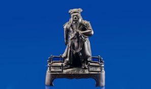 An Unusual Chinese Bronze of a Taoist Monk in formal attire holding his beard. One arm outstretched