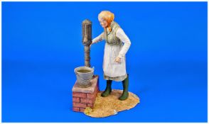 Sherratt and Simpson Hand Painted Figure Group . Old lady at the water pump. 8.5 inches high.