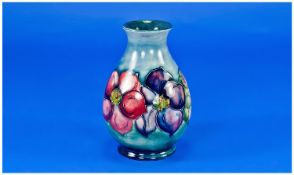 Moorcroft Small Vase `Clematis` design on pale blue ground. c 1950. Some over painting to rim edge