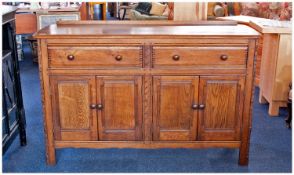 Ercol Oak Sideboard, fitted with two drawers over two doors, joined with pegged mortise and tenon