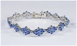 Tanzanite Cluster Bracelet, 11.25 carats of round, faceted tanzanite in lozenge shaped clusters,