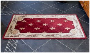 Small Embossed Chinese Rug, with fleur-de-lys decoration red ground to centre, ivory band, with a
