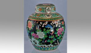 A fine enamalled Japanese lidded ginger jar painted with a peacock amogst flowers in the famille