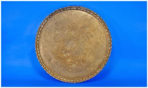 Circular Brass Tray, decorated to centre with engraved Arabic script, with petal moulded edge,
