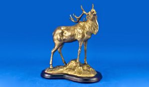 Brass Figure of A Stag, standing on a rocky base, on wooden stand. 12 inches in height.