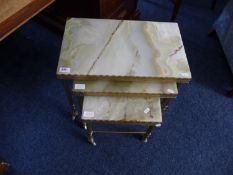 Onyx Topped Nest of Tables, with brass frames, rod stretchers, largest table 17 inches high, 20