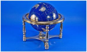Small Gemstone Globe, on a blue ground, raised on a brass stand, 12 inches high.