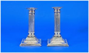 Edwardian Pair of Silver Corinthian Column Candlesticks, on stepped square bases. Hallmarked