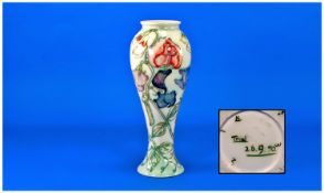 Moorcroft Trial Vase dated 26-09-90 with stylised floral design. Stands 10.75 inches tall.