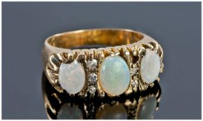 9ct Gold Opal Ring Set With Three Milk Opals Showing Flashes Of Greens And Blues, Set Between