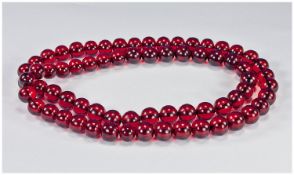 Long Strand Of Cherry Amber Beads, Length 35 Inches, Each Bead approx 14mm Diameter. Early 20thC