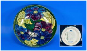 Moorcroft Large Footed Bowl `Clematis` Design on green ground. Signed to base. Overpainting to