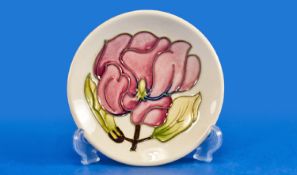 Moorcroft Pin Dish, with tube lined decoration, depicting magnolias on a cream ground, stamped to