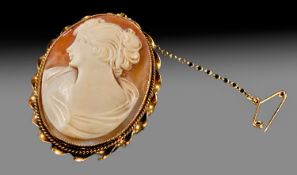 A 20th Century Shell Cameo Within a 9ct Gold Oval Frame. With safety chain. Fully hallmarked. 1.75