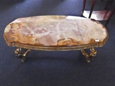 Large Onyx Topped Table, oblong form, the top raised on a Rococo style gilt frame, 18 high, 45 wide