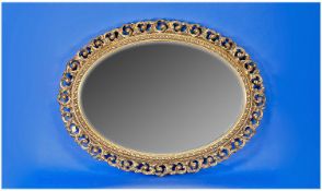 Oval Framed Gilt Mirror, the frame with acanthus scroll and piercework, with an inner band of