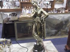 Large Gilt Figure of a Classical Lady, raised on a circular base.
