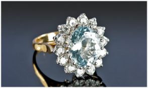 18ct Gold Set Large Aquamarine and Diamond Cluster Ring. The aquamarine flanked with 14 diamonds