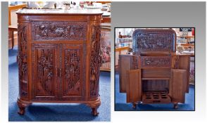 Oriental Hardwood Cocktail Cabinet, the top and front opening to reveal well below, bottle section