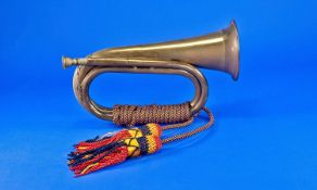 A Vintage Queens Own  Regiment Brass Bugle with attached rope and tazzle, 11.5 inches long.