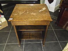 Early 20th Century Oak School Desk, the slope fronted lid opening to reveal storage section below,