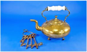 Brass Kettle, with white porcelain handle, raised on four feet, together with a collection of keys.