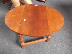 Small Oak Coffee Table, in the form of a drop leaf table, the top swivelling round supporting the