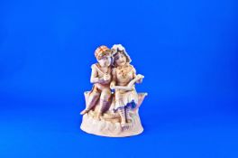 Late 19th Century Fine Quality Victorian Bisque Green Figure. Boy and girl reading a book, sitting