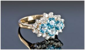 Ladies 9ct Gold Set Blue Topaz and Diamond Cluster Ring. The topaz flanked by 20 small diamonds.